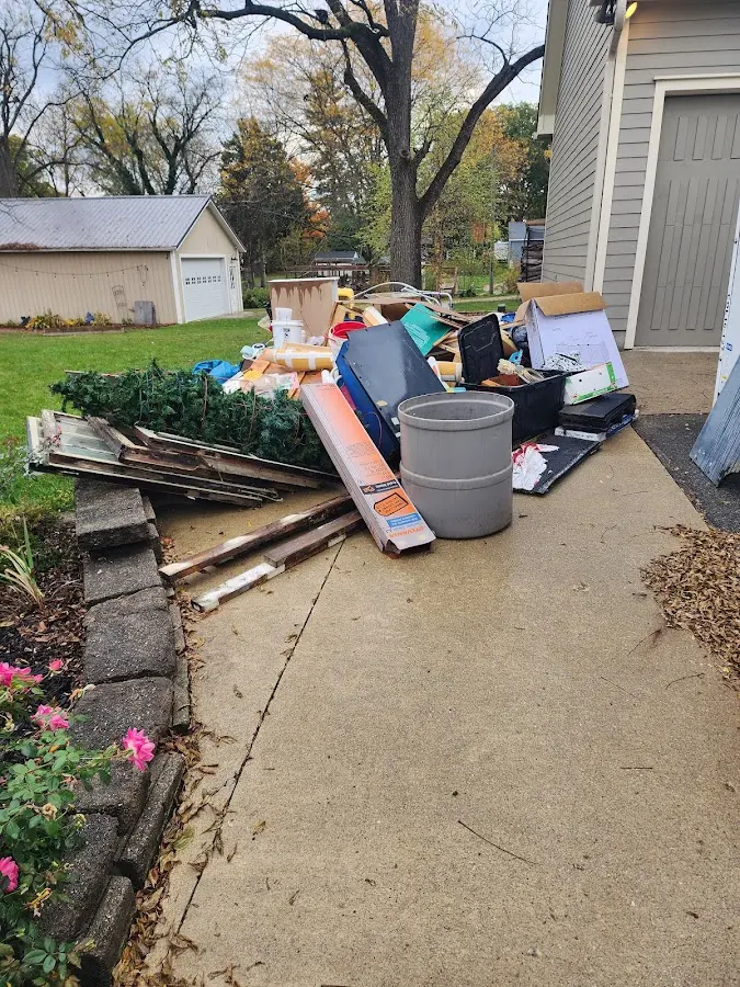 Dumpster being loaded with debris for Estate Cleanout Dumpster Rental in Godley